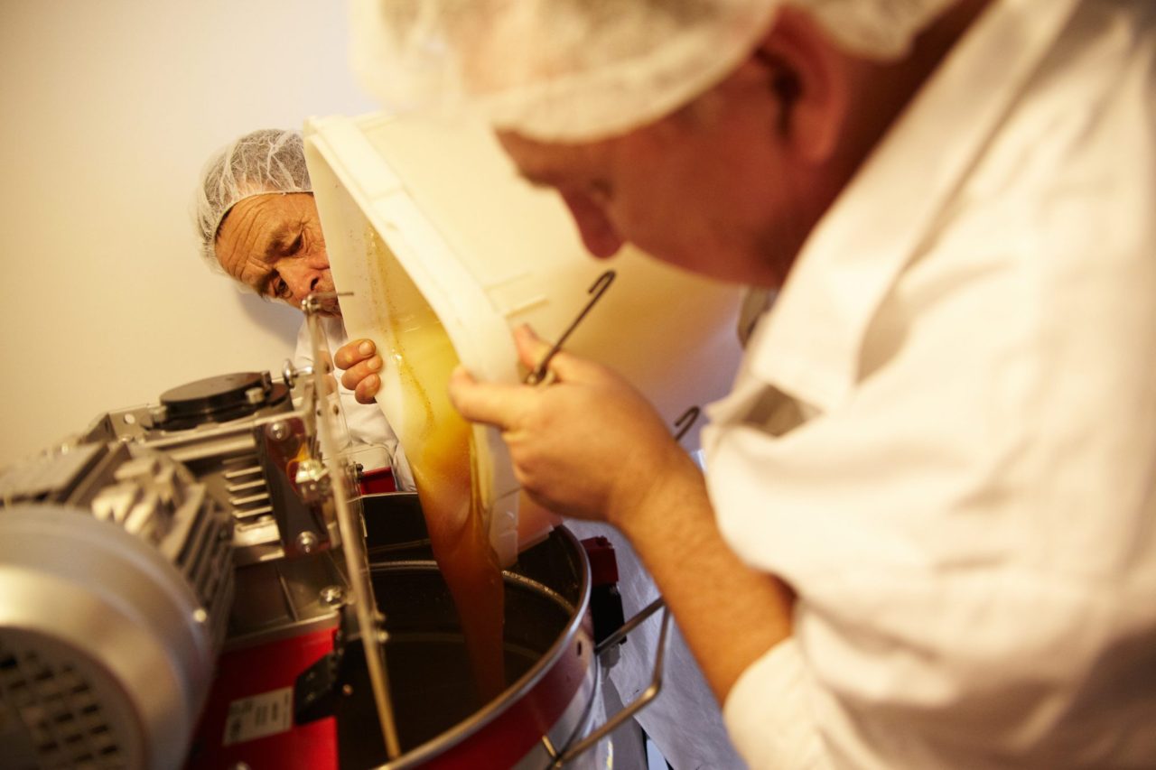 Равиль и его главный помощник по пасеке Фанзиль заливают свежий мед в бак для производства мусса